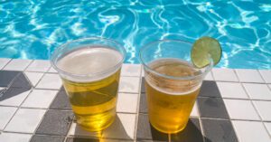 Two beers sitting beside the pool with crystal clear blue water at Radisson Blue Toronto Downtown Pool Lounge